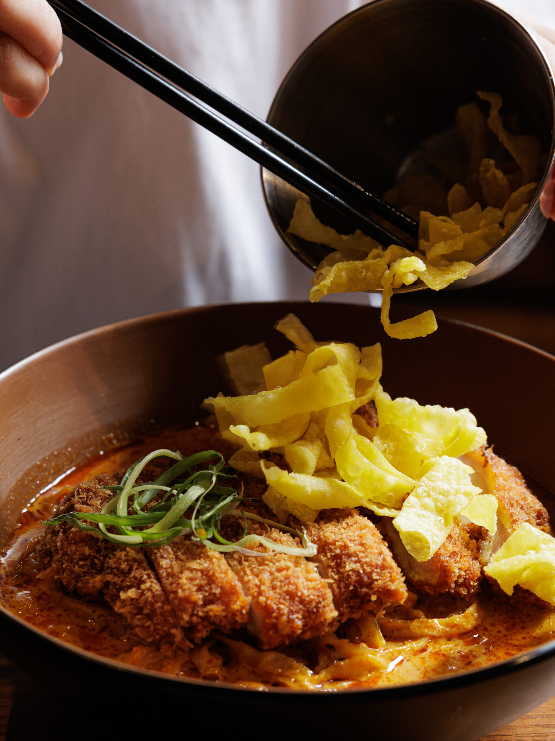 Khao Soi coconut curry noodle soup topped with crispy noodles at Khaosoi